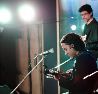 A new song, called 'Moving Forward', was presented to the audience – a very melodic storytelling song with the charango and violins floating around. Tajdar himself was smiling through the duration of the song.<br/><span class='courtesyName'> Photo Courtesy - Margub Ali  </span> 